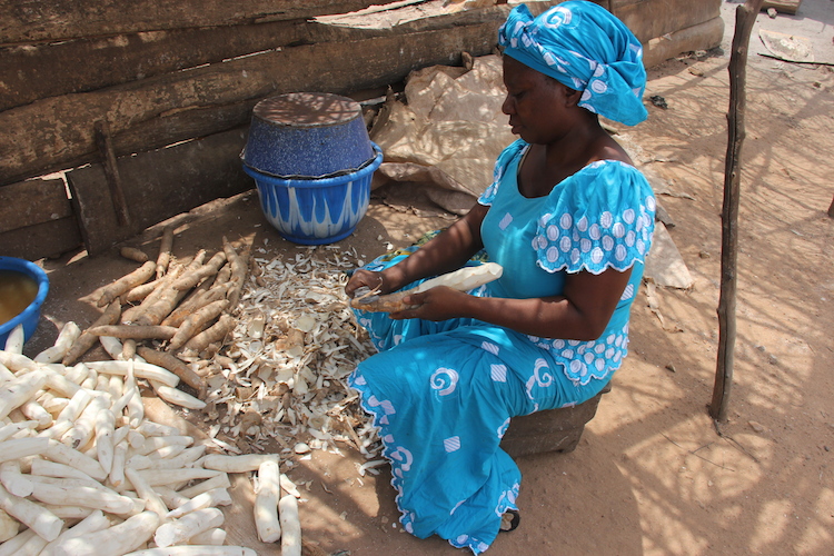 Lady peeling cassava. Photo: Lora Forsythe