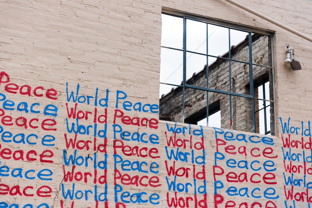 Graffiti on a wall reads ‘World Peace’; Dr Uche Okpara’s work as part of the Future Leaders Fellowship will look at prosperity and peace | Photo: Unsplash