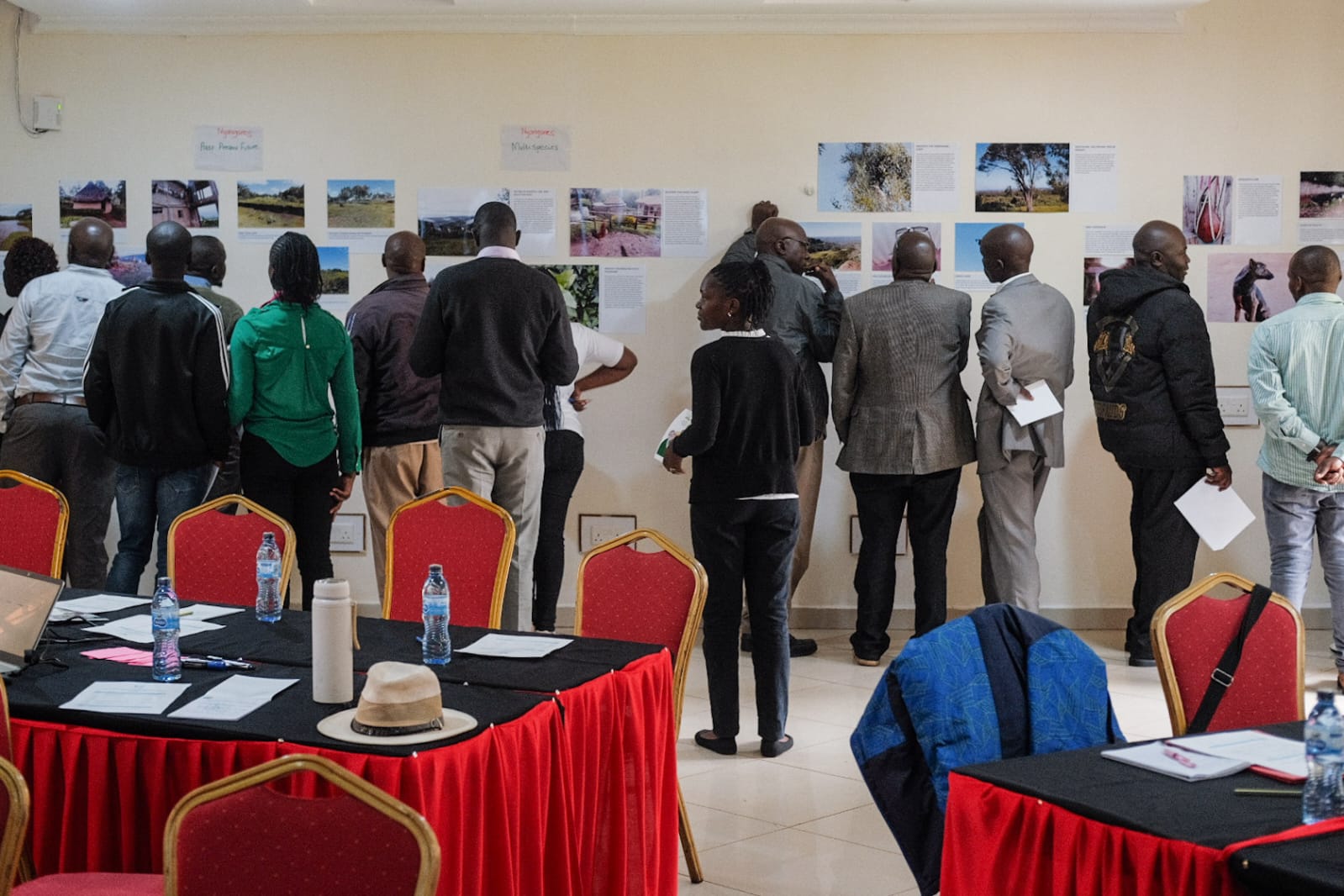  Participants discussing while viewing photos from photovoice projects completed during prior TCforBE work